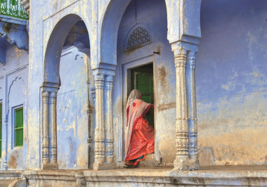 woman-entering-traditional-indian-house